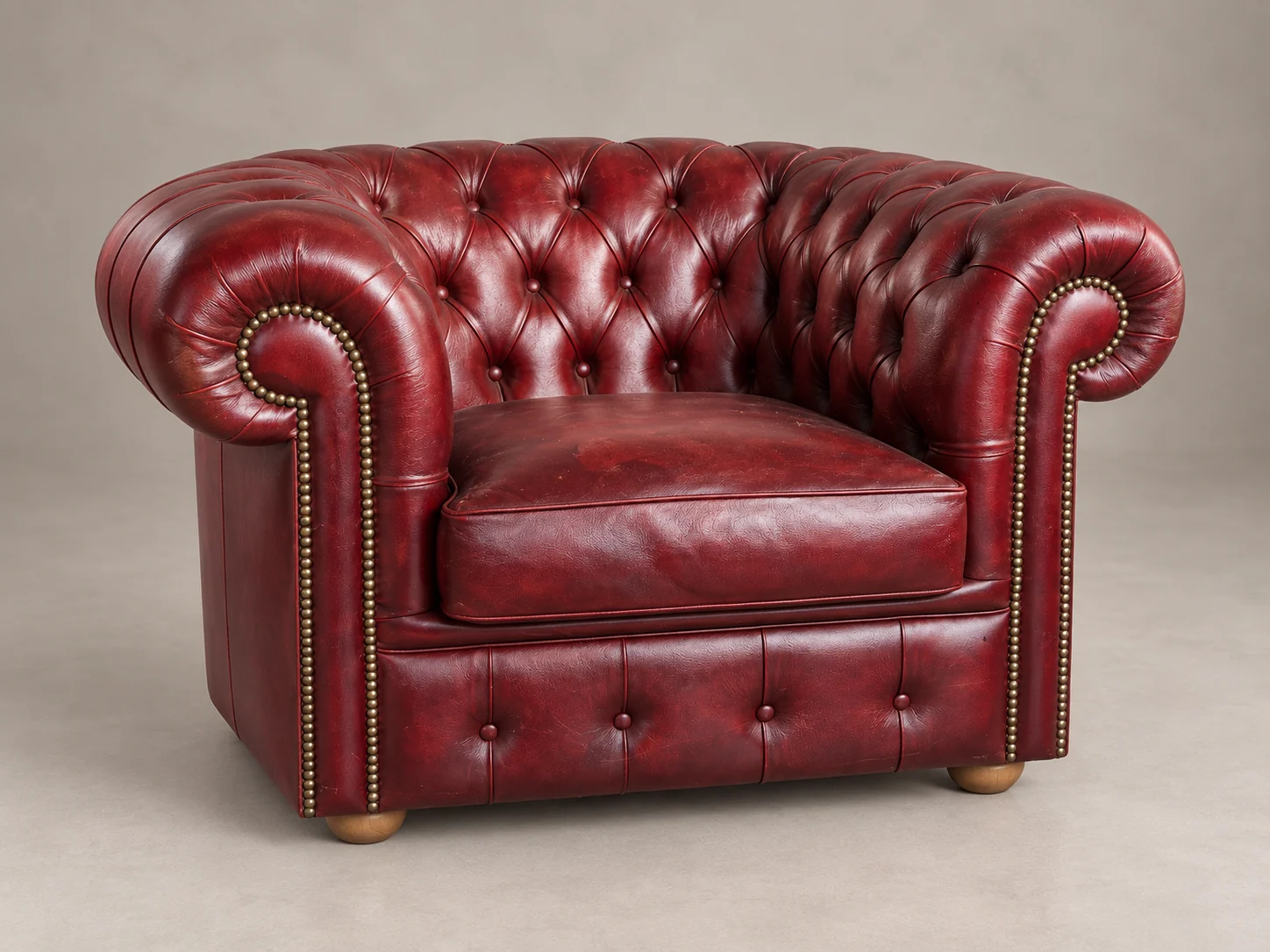 Render di una poltrona capitonné in pelle rossa